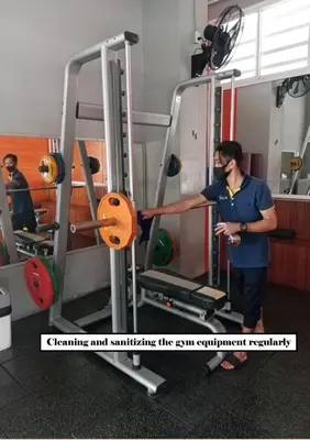 a man standing in front of a gym at Witchuwan Apartel in Bangkok