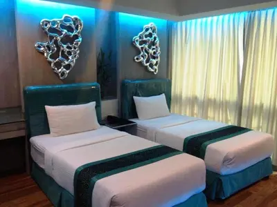 two beds in a room with hearts on the wall at Blutique Hotel in Bangkok