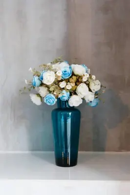 a blue vase filled with blue and white flowers at Blutique Hotel in Bangkok