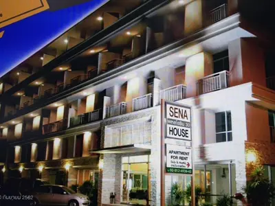 a large apartment building with a sign in front of it at Sena House in Bangkok