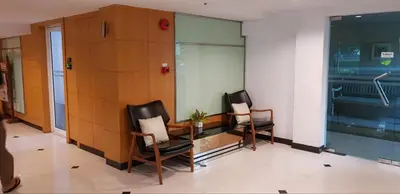 two chairs sitting in a waiting room in a building at Sena House in Bangkok