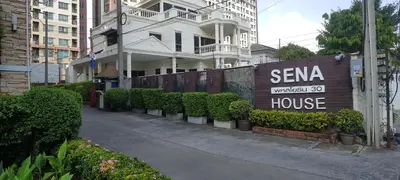 a sign for a tema house in front of a building at Sena House in Bangkok