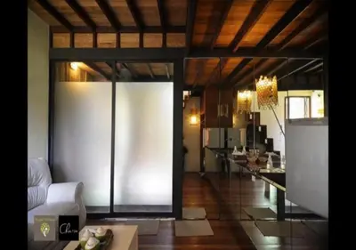 a living room with a large sliding glass door at Bangkok Tree House Bang Kachao in Bangkok