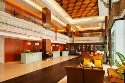 a lobby of a hotel with couches and chairs at The Davis Bangkok in Bangkok