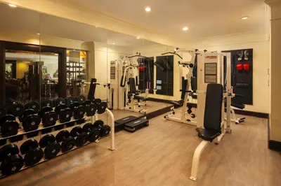 a gym with lots of equipment in a room at The Davis Bangkok in Bangkok