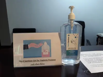 a bottle of hand sanitizer sitting next to a box at House 23 Guesthouse in Bangkok