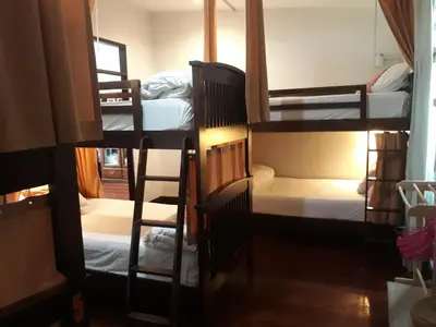 a group of bunk beds in a room at House 23 Guesthouse in Bangkok