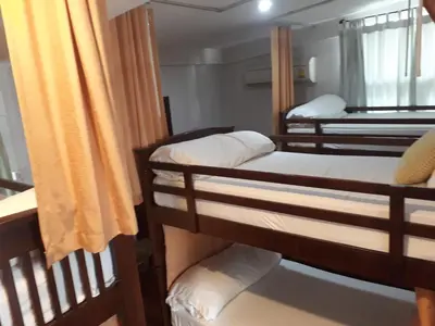 a group of bunk beds in a room at House 23 Guesthouse in Bangkok