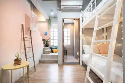 a room with two bunk beds and a staircase at Better Moon Guesthouse in Bangkok