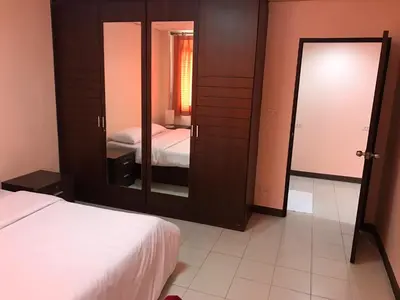 a bedroom with a large mirror and a bed at De Junction House in Bangkok