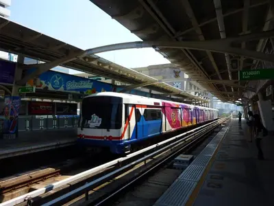 a train is pulling into a train station at Aphrodite Inn Bangkok in Bangkok