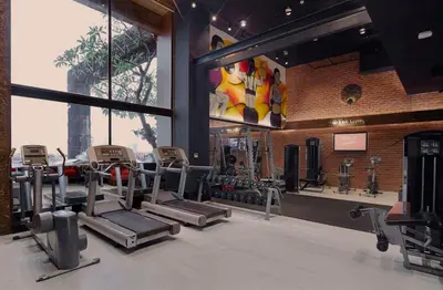 a gym with cardio equipment in a brick wall at Siam At Siam Design Hotel Bangkok in Bangkok