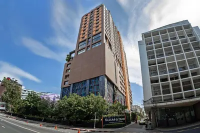 a tall building on the side of a street at Siam At Siam Design Hotel Bangkok in Bangkok