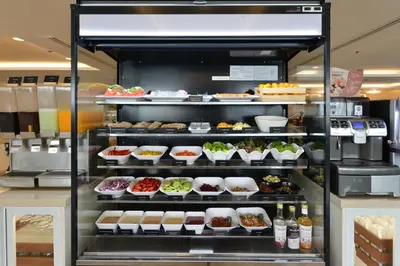 a display case filled with different types of food at Centre Point Plus Hotel Silom - Newly Renovated in Bangkok