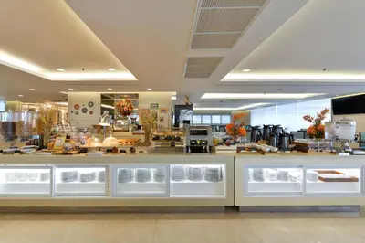 a bakery with a counter in a store at Centre Point Plus Hotel Silom - Newly Renovated in Bangkok