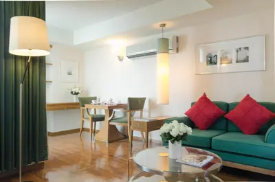 a living room with a couch and a table at AT EASE saladaeng by AETAS in Bangkok