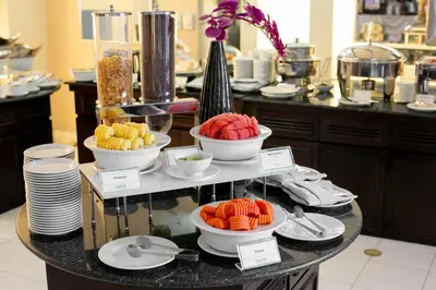 a buffet with bowls of food on a table at AT EASE saladaeng by AETAS in Bangkok