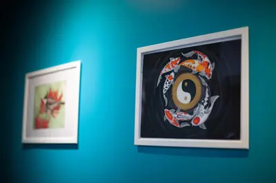 two pictures on a blue wall with a number eight at Clean Comfy Cozy easy to go Siam Paragon and Chatuchak Market in Bangkok