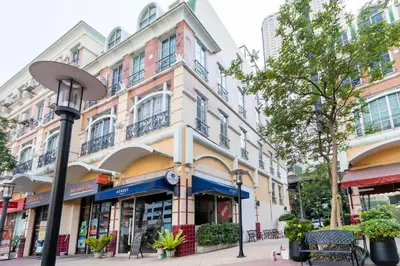 a building on a city street with a street light at Atnest Hostel in Bangkok