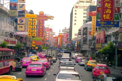 a busy city street filled with lots of cars at Atnest Hostel in Bangkok