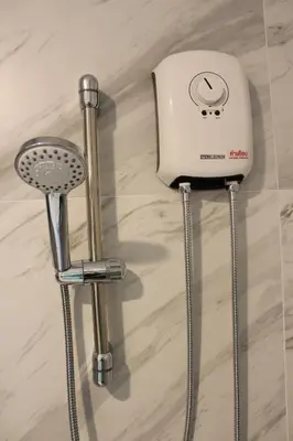 a toaster and two stools sitting on a counter at Atnest Hostel in Bangkok