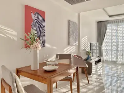 a dining room with a table and a zebra picture on the wall at Sukhumvit Asok Modern Suite in Bangkok