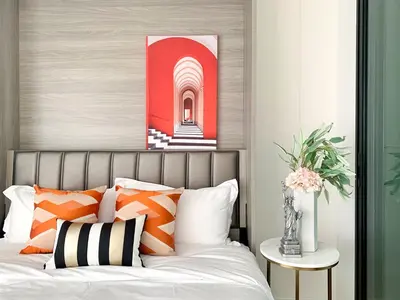 a bedroom with a bed with orange and white pillows at Sukhumvit Asok Modern Suite in Bangkok