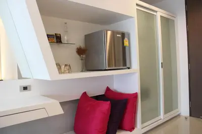 a kitchen with red pillows and a refrigerator at Nine Forty One Hotel in Bangkok