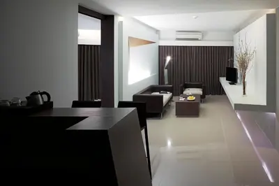 a living room with a couch and a table at Nine Forty One Hotel in Bangkok