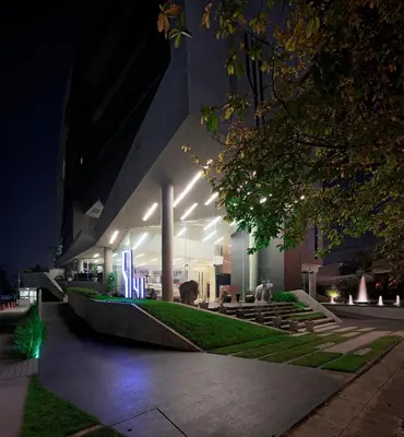 a building with lights on the side of it at night at Nine Forty One Hotel in Bangkok