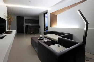 a living room with a couch and a table at Nine Forty One Hotel in Bangkok