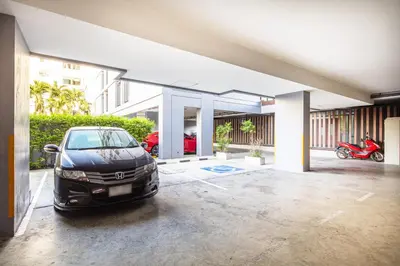 a car parked in a parking lot in a garage at Aliz Hotel in Nonthaburi