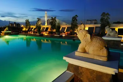 a swimming pool with a statue in front of it at Rambuttri Village Plaza in Bangkok