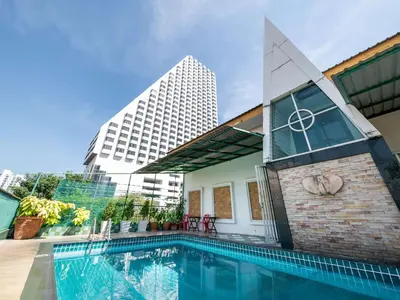 a swimming pool in front of a building at Royal Ivory Sukhumvit Nana in Bangkok