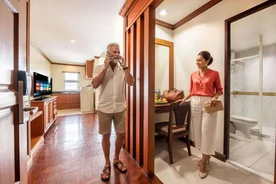 a man taking a picture of a woman in a kitchen at Royal Ivory Sukhumvit Nana in Bangkok