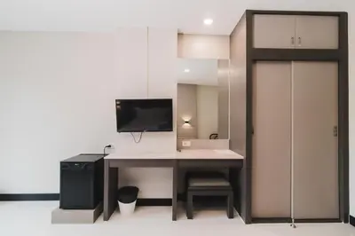 a room with a desk with a tv on top at So good Hotel Bangkok in Bangkok