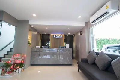 a lobby with a couch and a reception desk at So good Hotel Bangkok in Bangkok