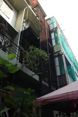 an apartment building with a balcony with plants on it at NBH.@ Prannok in Bangkok