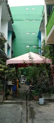 a pink umbrella in front of a building at NBH.@ Prannok in Bangkok