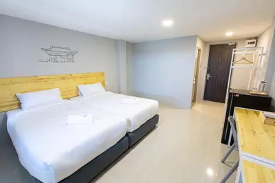 a bedroom with a large bed with white sheets at Fine Bed Hotel in Nonthaburi