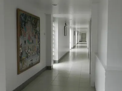 a hallway with a painting on the wall and a corridorngthngthngthngthngth at City Residence Rama 6 in Bangkok