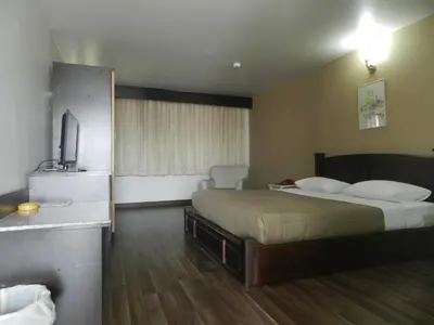 a hotel room with a bed and a television at City Residence Rama 6 in Bangkok