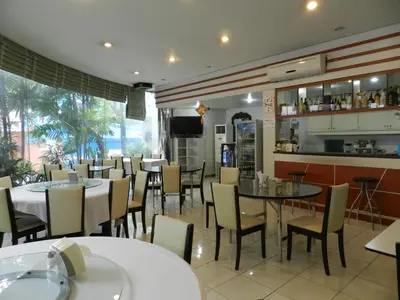 a restaurant with tables and chairs and a bar at City Residence Rama 6 in Bangkok