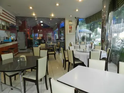 a dining room with tables and chairs in a restaurant at City Residence Rama 6 in Bangkok