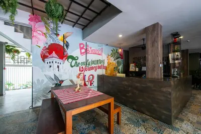 a restaurant with a table in front of a counter at BB House Rambuttri2 บีบี เฮ้าส์ รามบุตรี2 in Bangkok