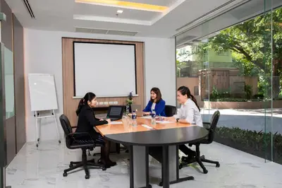 three women sitting around a table in a conference room at Adelphi Grande Sukhumvit in Bangkok