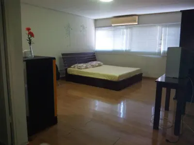 a small bedroom with a bed and a window at T8 IMPACT BANGKOK Thailand in Bangkok