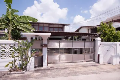 a house with a gate and a fence at Dunah's Garden Home in Bangkok