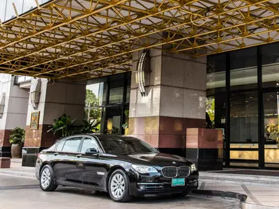 a black car parked in front of a building at Emporium Suites by Chatrium in Bangkok