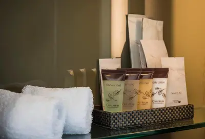 a basket of towels and products on a table at Emporium Suites by Chatrium in Bangkok